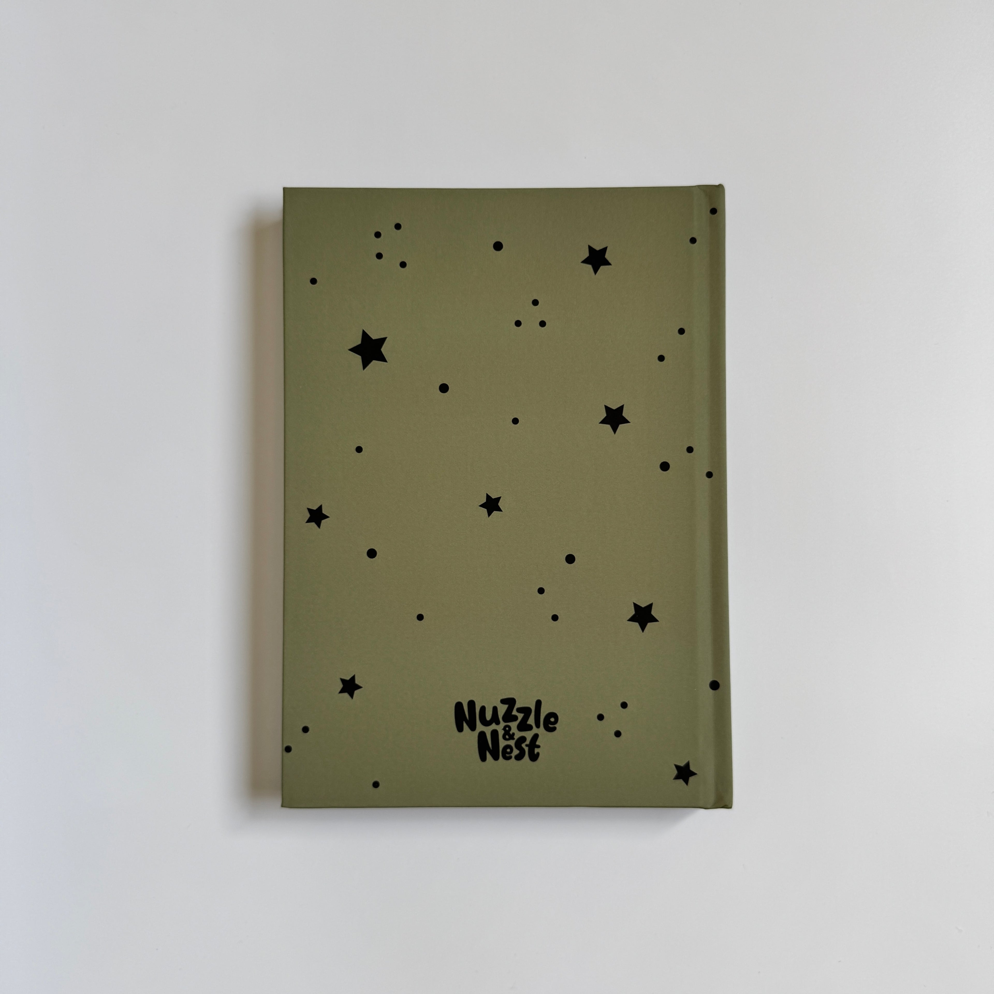 Green notebook with black star patterns and &