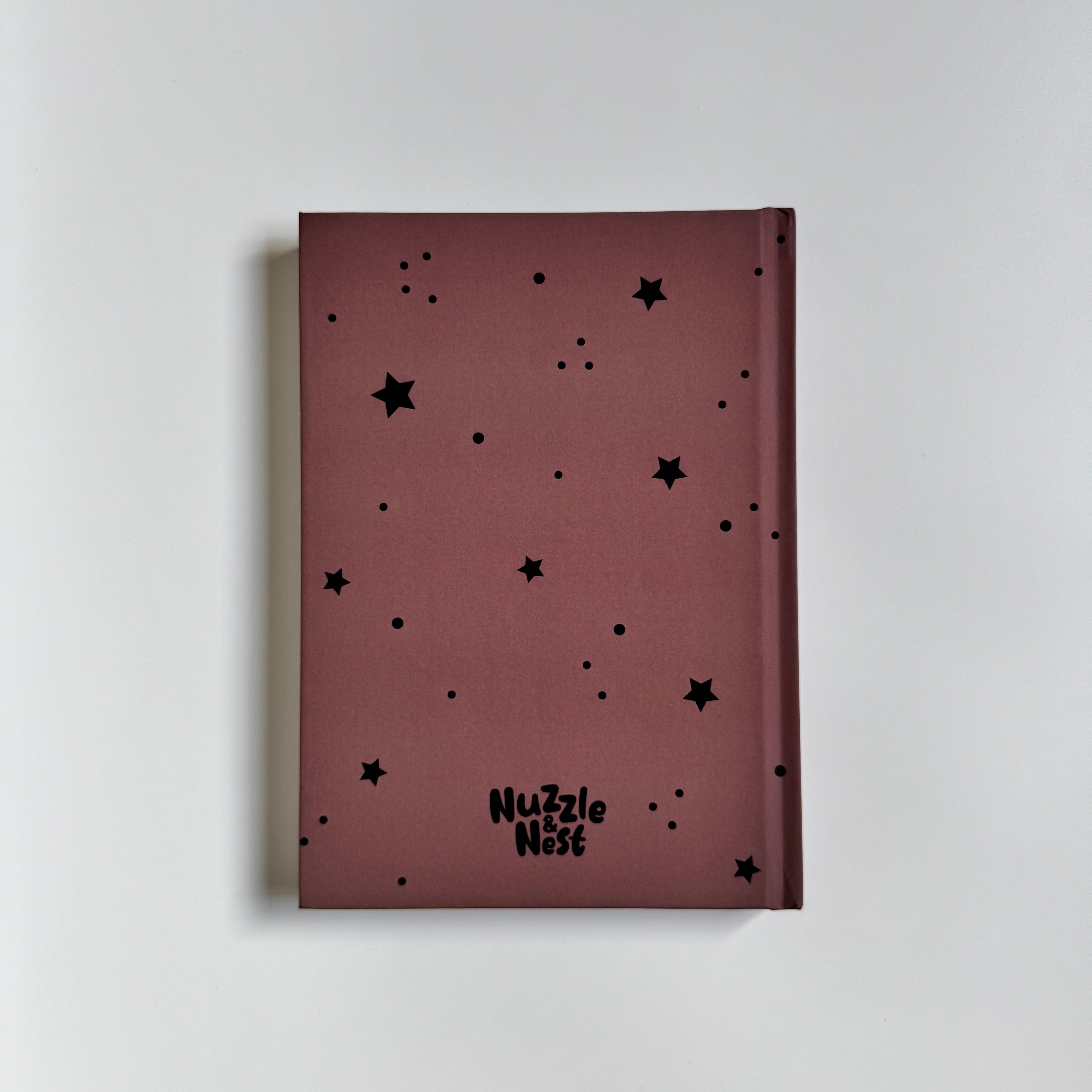 Maroon notebook with black star patterns on a light gray background