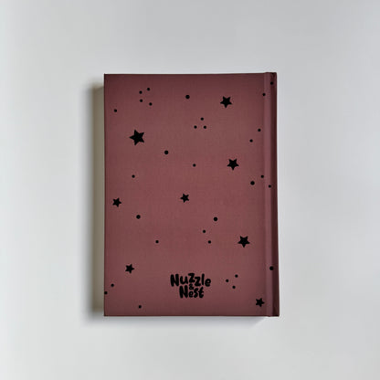 Maroon notebook with black star patterns on a light gray background
